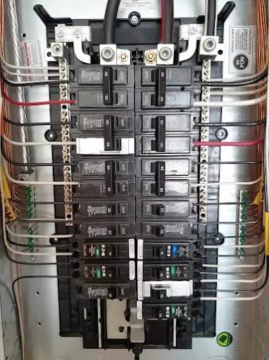 Electrical panel with circuit breakers, wiring, and main disconnect switch installed