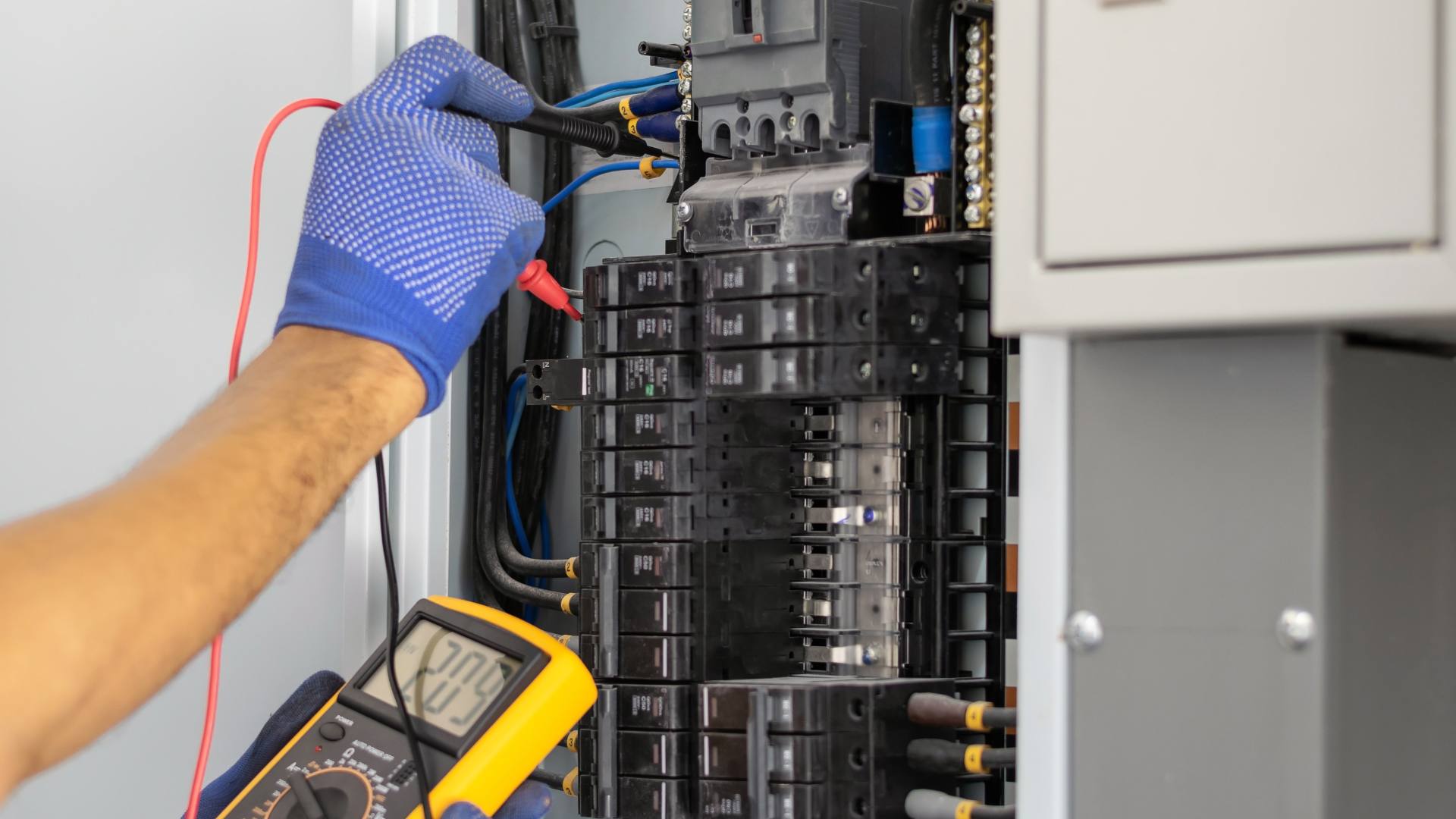 Electrician testing a service panel